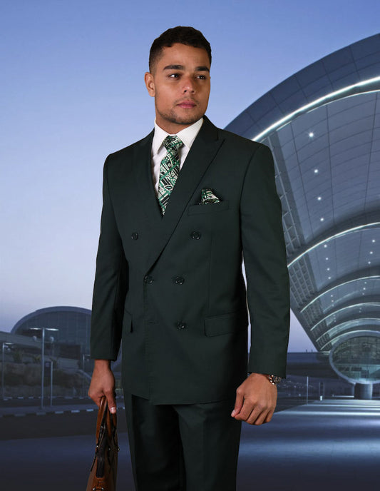 A man in the STATEMENT CLOTHING | TZD-100-HUNTER Italian wool suit by Statement Clothing, paired with a patterned tie and briefcase, stands outside a modern curved building at dusk.
