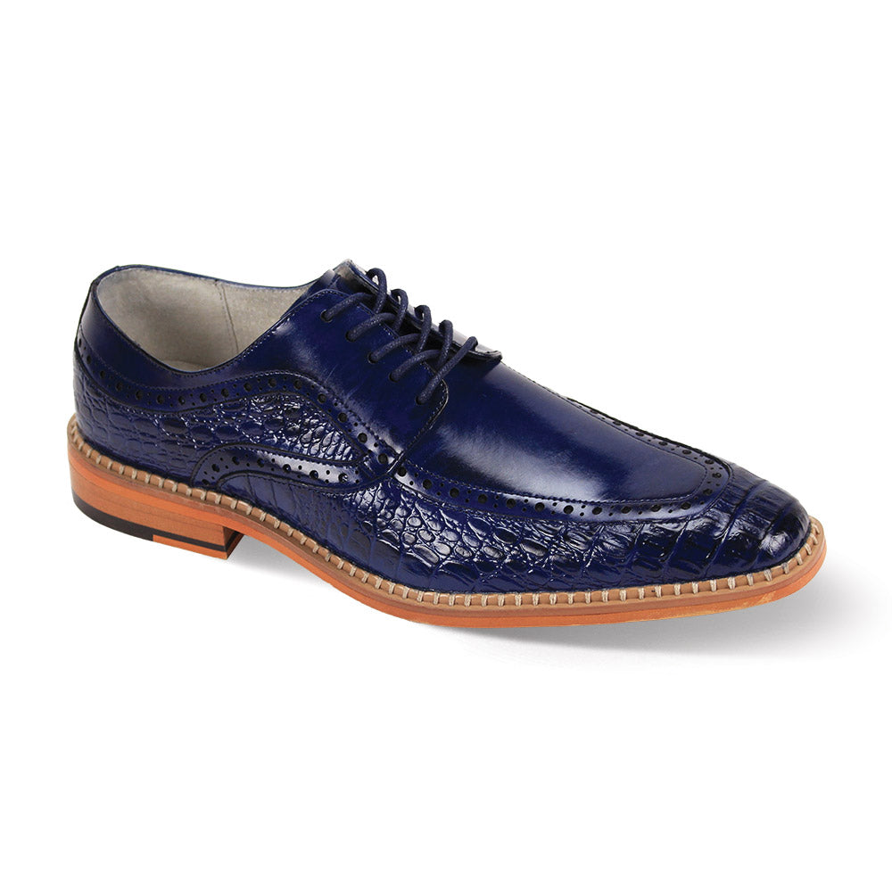 The Giovanni Terence Cobalt Leather Shoes by GIOVANNI are blue leather brogues with a smooth upper, detailed stitching, Moc Toe design, and light brown sole.