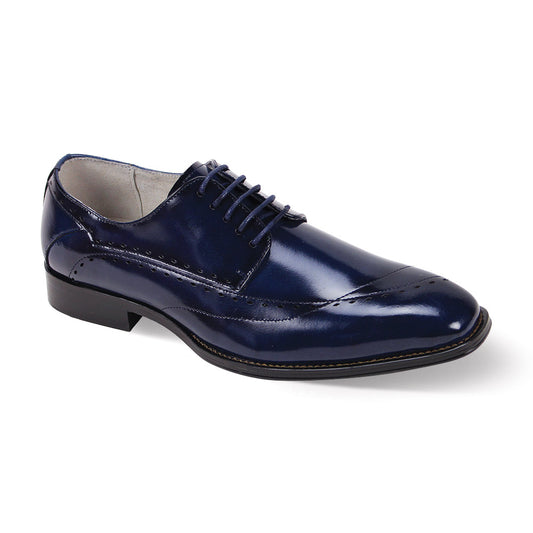 The Giovanni Triston Blue Leather Shoes by GIOVANNI are dark blue polished wingtips with intricate stitching and asymmetrical laces, featuring a low heel, displayed against a plain background.