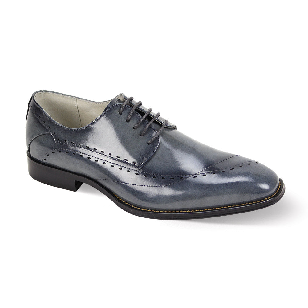 The Giovanni Triston Grey Leather Shoe by GIOVANNI features a polished dark gray finish with brogue detailing, black laces, and intricate stitch accents.