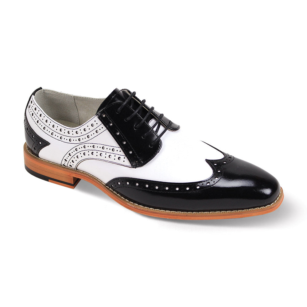 The Giovanni Troy Black/White Leather Shoes by GIOVANNI are wingtip oxfords with asymmetrical perforations, intricate stitching, and a wooden sole.