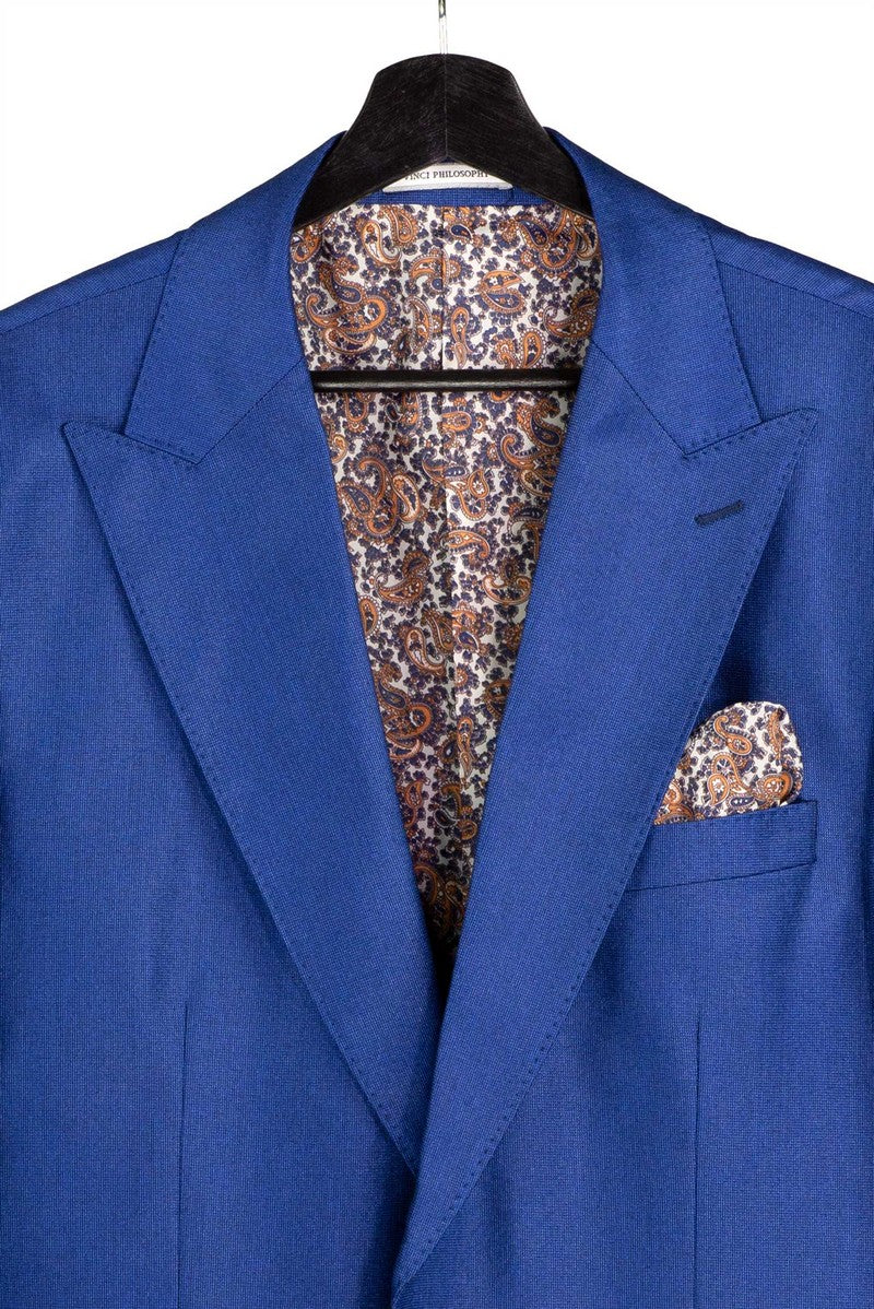 The Vinci Suits Regular Fit Estate Blue 3 Piece Sharkskin Suit with Vest and Adjustable Waistband Pants V2RK-5 is styled with a white shirt, paisley tie, gold chain, and pocket square.