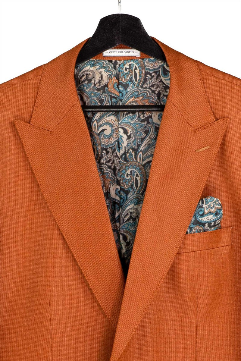 The Vinci Suits Regular Fit Rust 3 Piece Sharkskin Suit with Vest and Adjustable Waistband Pants V2RK-5 is styled with a navy shirt, paisley tie, and matching pocket square on a mannequin.