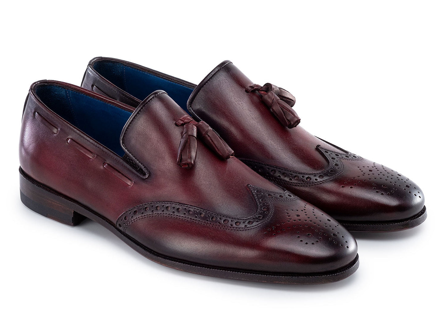 The Paul Parkman Wingtip Tassel Loafers Bordeaux (WL34-BRD) are men's hand-painted calfskin loafers in burgundy, featuring perforated detailing, blue inner lining, and displayed on a white background.