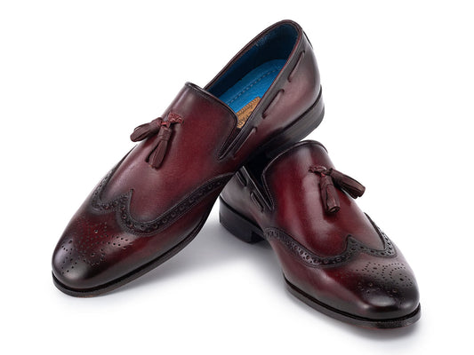 The Paul Parkman Wingtip Tassel Loafers Bordeaux (WL34-BRD) are men's hand-painted calfskin loafers in burgundy, featuring perforated detailing, blue inner lining, and displayed on a white background.