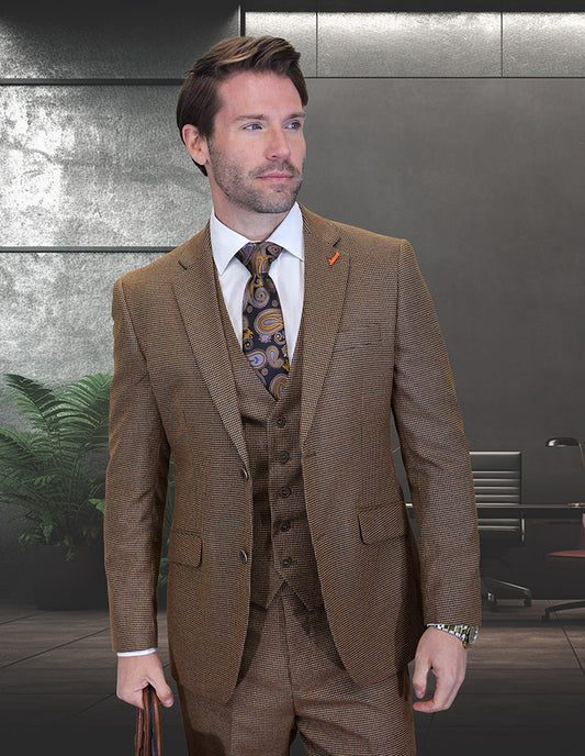A man in the STATEMENT CLOTHING | ZILONI-3-COPPER modern fit Italian wool suit by Statement Clothing and a paisley tie stands in a contemporary office with dark walls, office furniture, and a plant in the background.