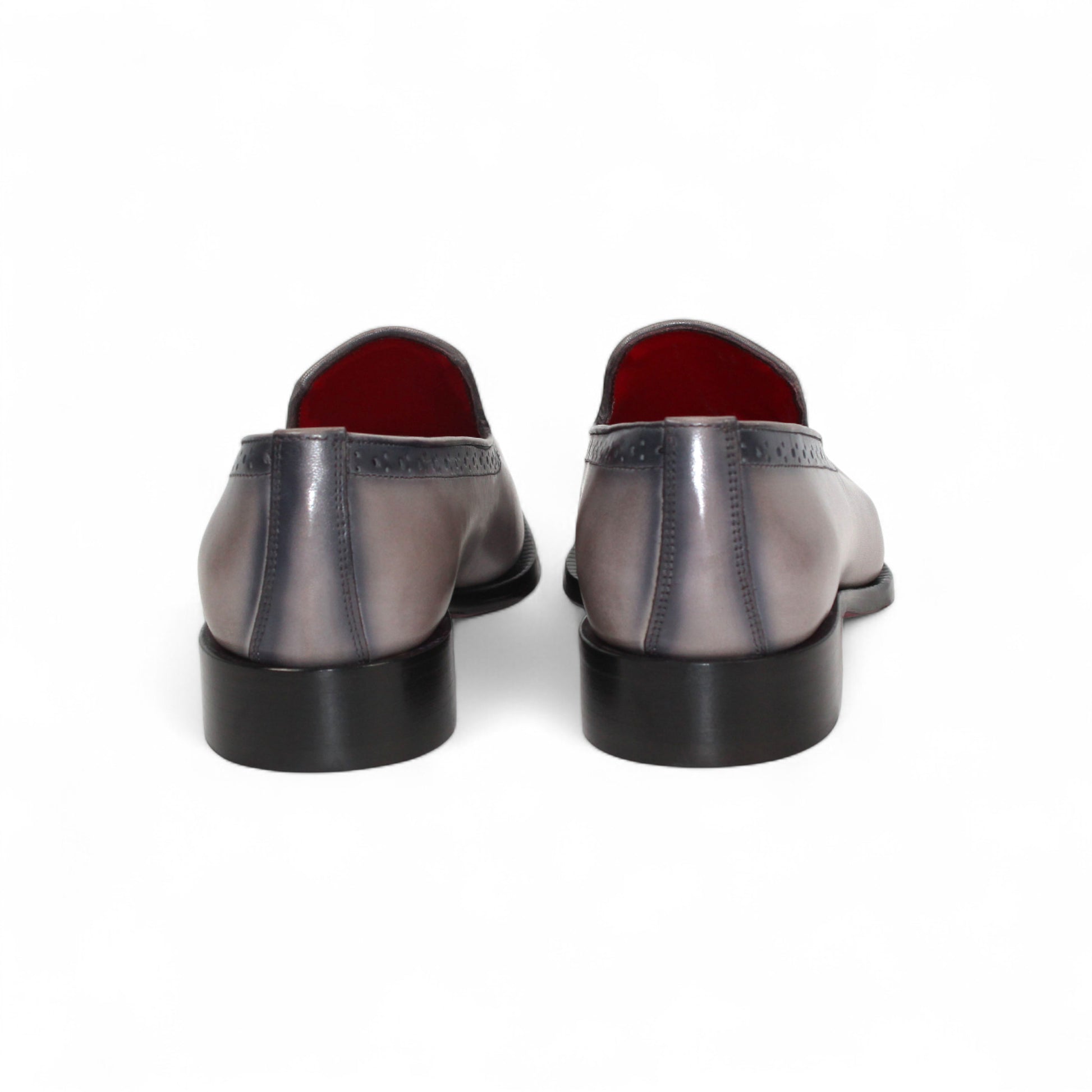 The Emilio Franco A014 Gray men's loafer features genuine grey leather, black toe and heel caps, subtle brogue details, red lining, and a low black heel—capturing minimalist style in a striking side profile.