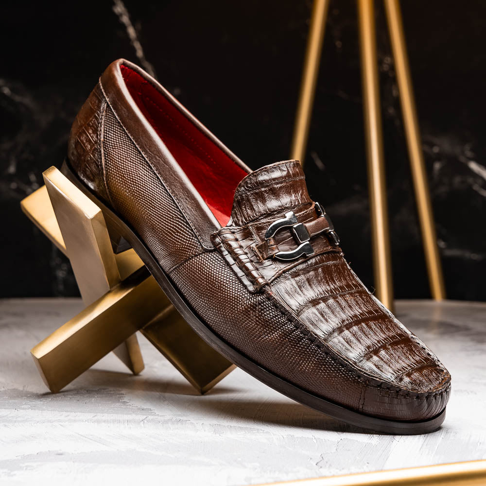 Introducing the Adro Brown by Marco Di Milano—crafted in brown leather with crocodile texture, silver buckle, red interior lining, and signature sole logo. A luxurious choice for those who value genuine exotic design.