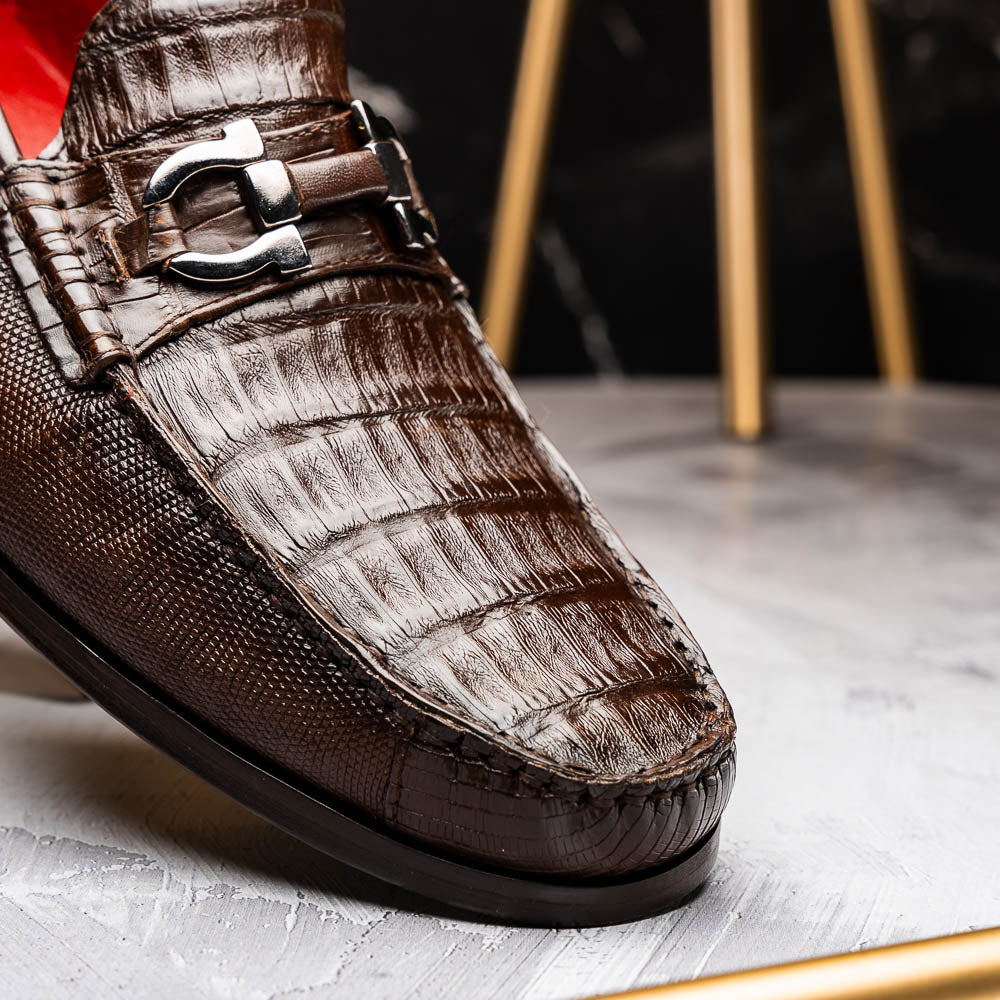Introducing the Adro Brown by Marco Di Milano—crafted in brown leather with crocodile texture, silver buckle, red interior lining, and signature sole logo. A luxurious choice for those who value genuine exotic design.