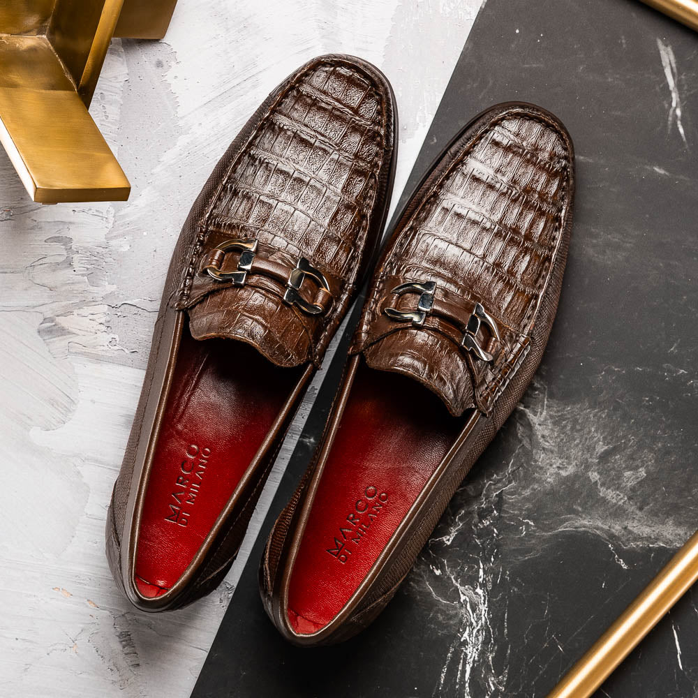 Introducing the Adro Brown by Marco Di Milano—crafted in brown leather with crocodile texture, silver buckle, red interior lining, and signature sole logo. A luxurious choice for those who value genuine exotic design.