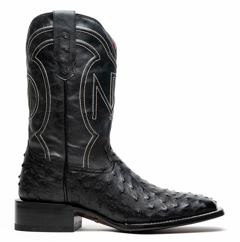 The Alabama Black by Marco Di Milano: a pair of black ostrich skin cowboy boots with white stitching, shown from side and sole views. These luxury men's boots combine classic western style with superb craftsmanship.
