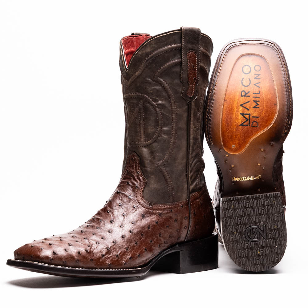 A pair of Marco Di Milano Alabama Kango Tabac men’s boots, handcrafted with genuine ostrich skin foot and dark upper, one upright and one displaying the branded sole, showcase classic Western cowboy style.