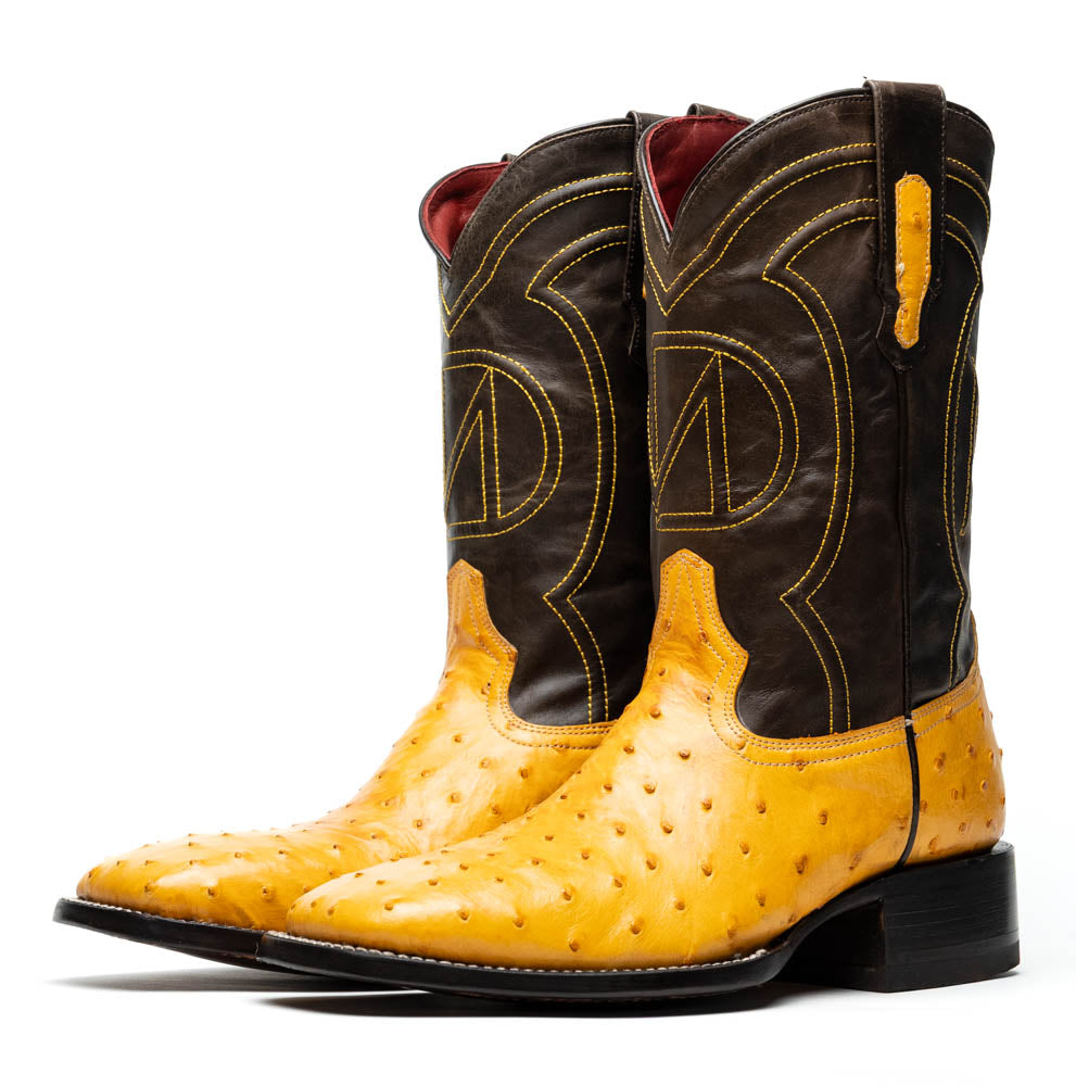 Introducing the Alabama Buttercup by Marco Di Milano: handcrafted cowboy boots with yellow genuine ostrich skin on the foot, dark brown leather shafts, and signature branding embossed on the sole.