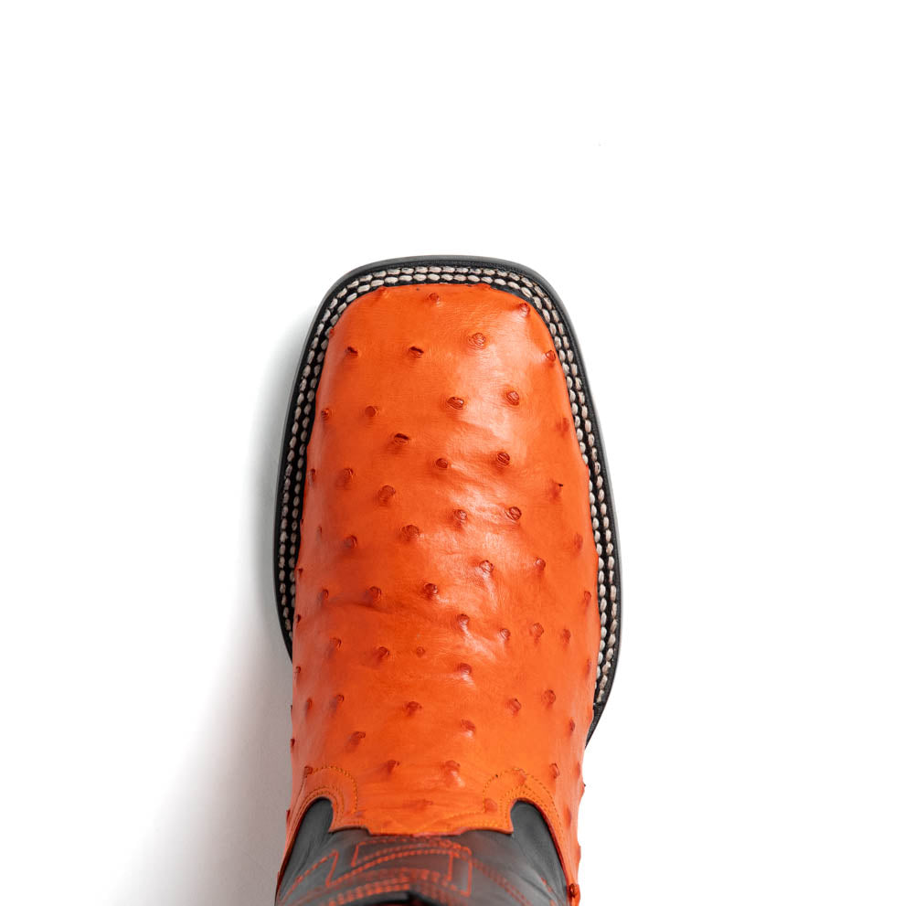 A pair of Alabama Orange cowboy boots by Marco Di Milano featuring a textured orange and black genuine ostrich upper and a visible logo on the leather sole.