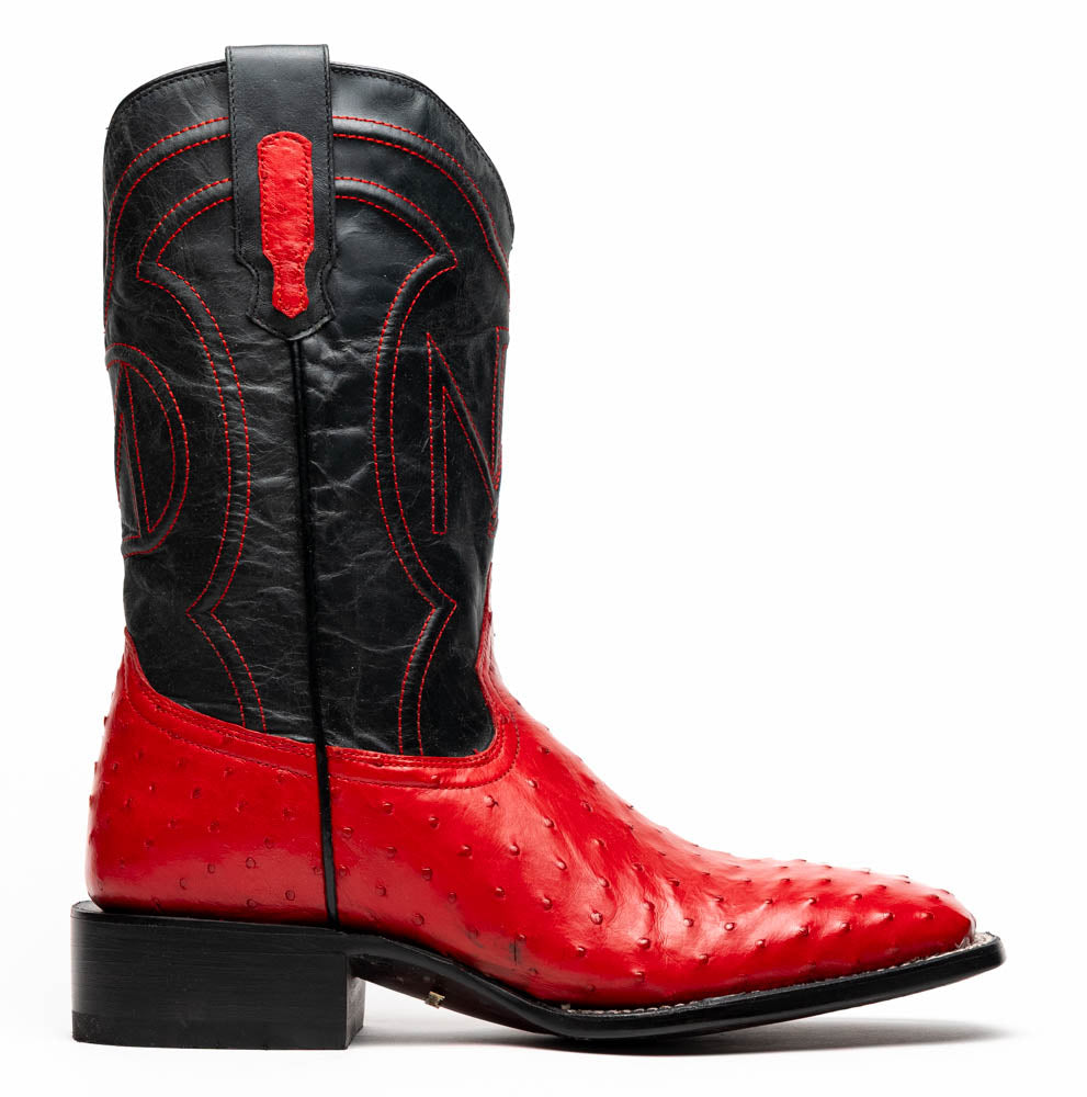 The Marco Di Milano Alabama Red boots feature handcrafted red and black textured leather; one stands upright while the other reveals the branded sole—a modern take on classic Western style.