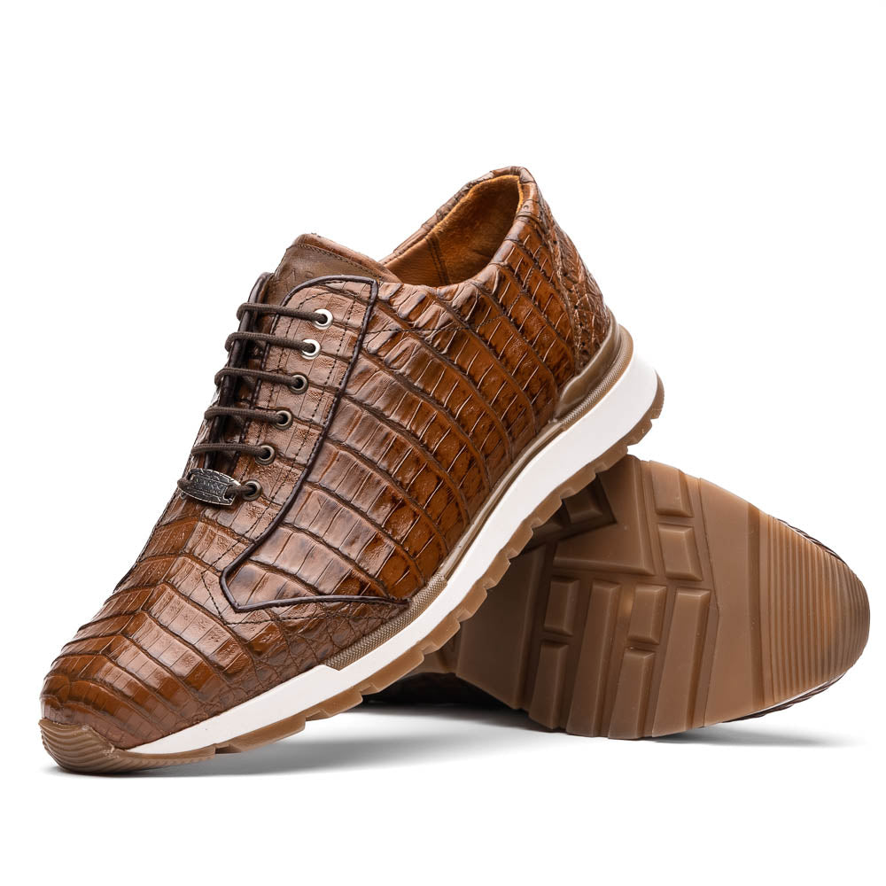 The Marco Di Milano Alonzo Bay Apache sneakers feature brown genuine caiman crocodile leather, white midsoles, brown rubber outsoles, a lace-up design, and a textured pattern—luxury footwear ideal for any occasion.