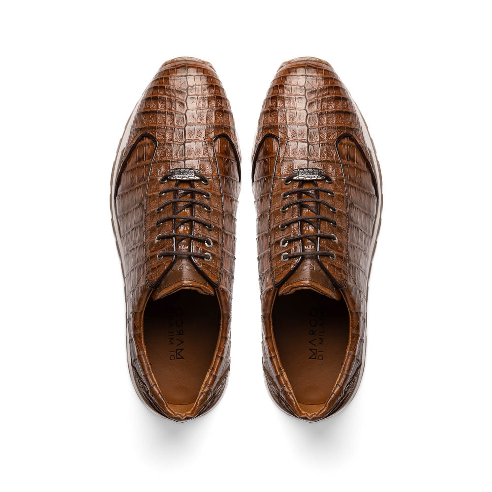 The Marco Di Milano Alonzo Bay Apache sneakers feature brown genuine caiman crocodile leather, white midsoles, brown rubber outsoles, a lace-up design, and a textured pattern—luxury footwear ideal for any occasion.