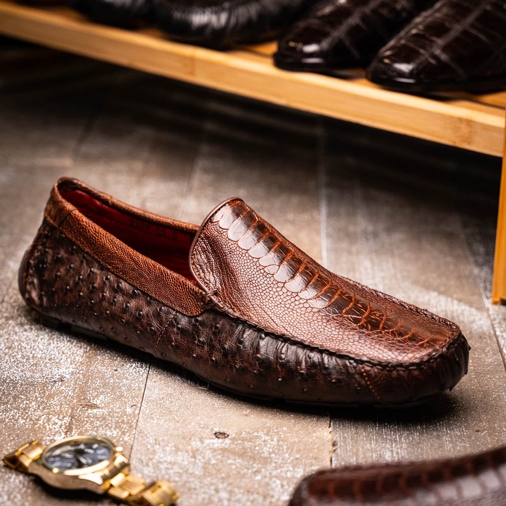 The Alba Kango Tabac by Marco Di Milano: brown textured leather loafers with visible stitching, one flat and one side-propped to reveal the sole—luxury footwear with artisanal hand-painted finishes.