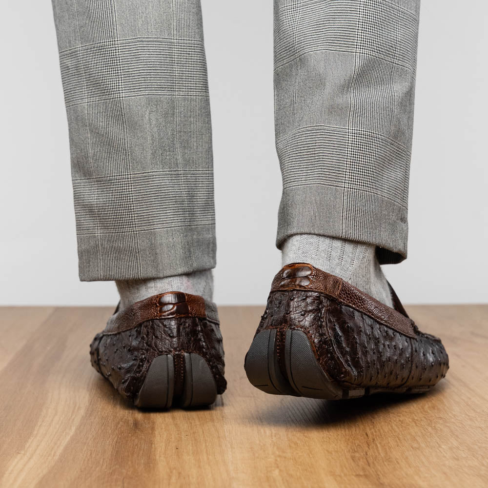 The Alba Kango Tabac by Marco Di Milano: brown textured leather loafers with visible stitching, one flat and one side-propped to reveal the sole—luxury footwear with artisanal hand-painted finishes.