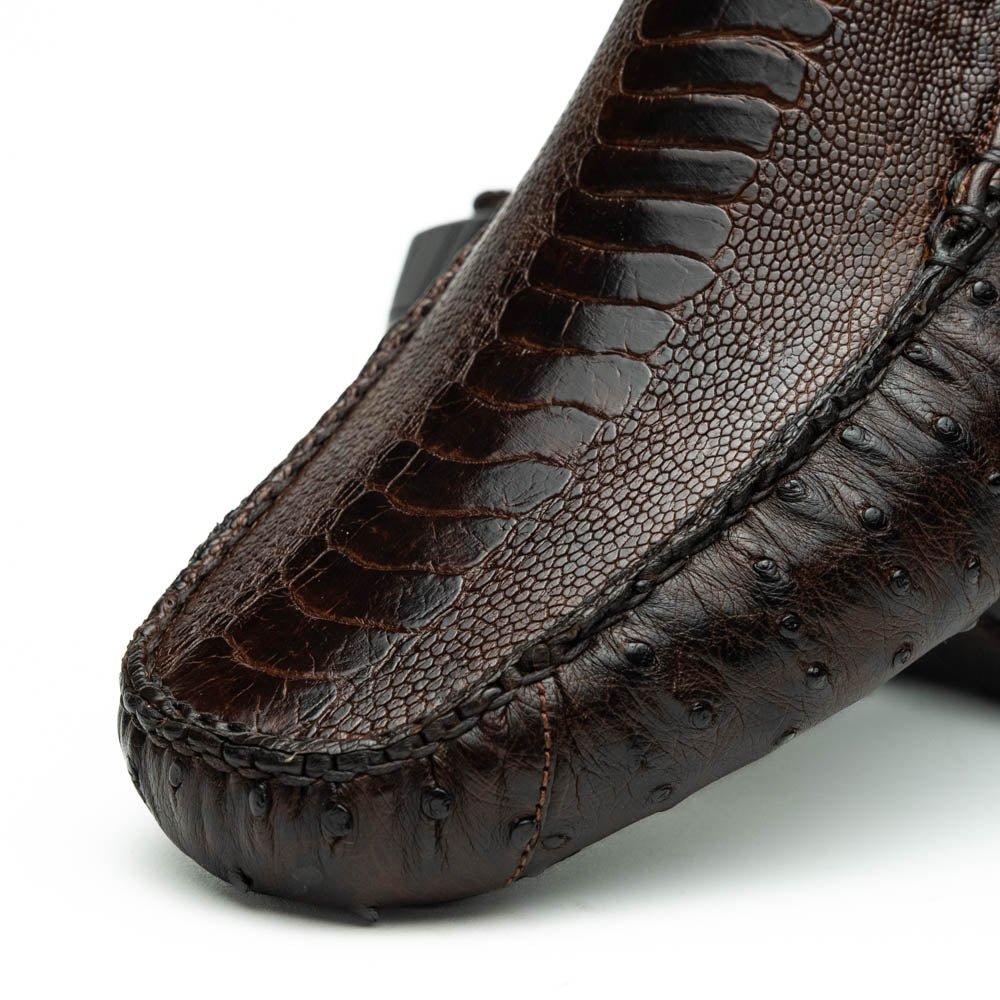 The Alba Kango Tabac by Marco Di Milano: brown textured leather loafers with visible stitching, one flat and one side-propped to reveal the sole—luxury footwear with artisanal hand-painted finishes.