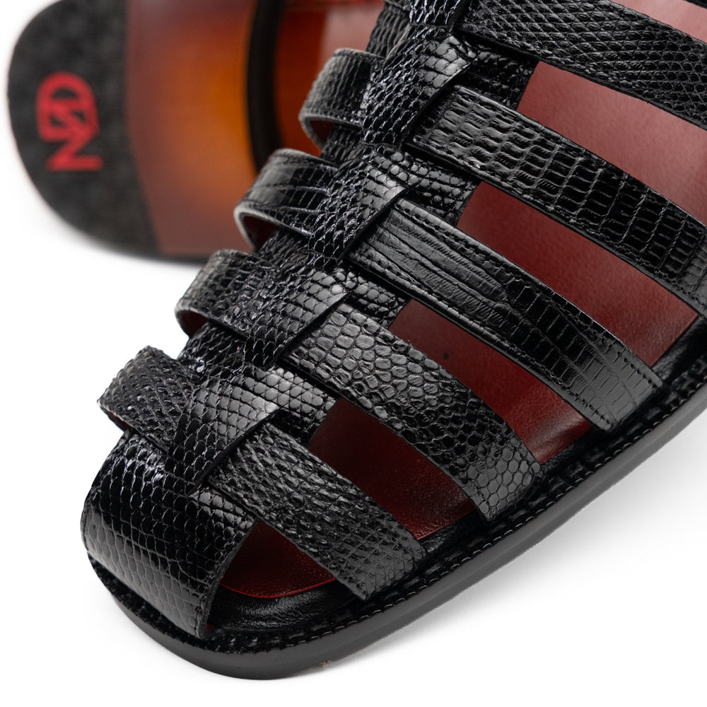 Albero Black handcrafted black leather gladiator-style sandal featuring a buckled ankle strap and a red goat leather interior lining.