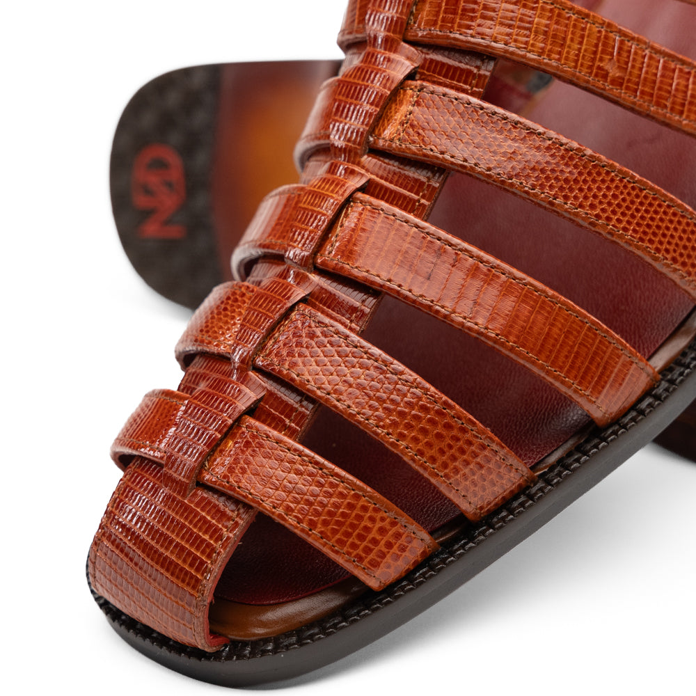 Marco Di Milano Albero Brandy: handcrafted brown leather gladiator-style sandal with a buckled ankle strap, a low heel, and genuine lizard ring detailing.