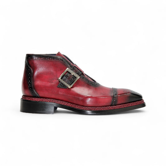 The Emilio Franco Aldo Antique Red is a genuine leather dress shoe with a black cap toe, decorative perforations, side buckle, and black heel—ideal for anyone seeking the elegance of Italian footwear.