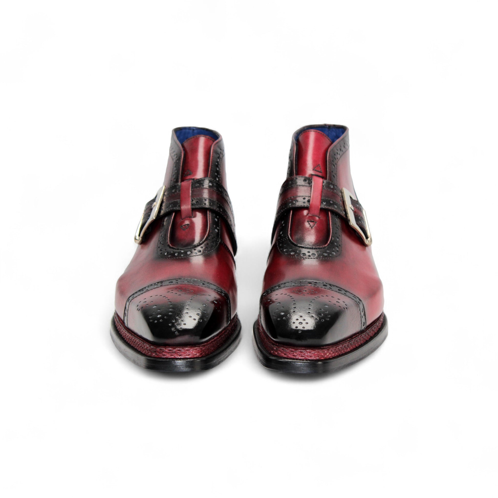 The Emilio Franco Aldo Antique Red is a genuine leather dress shoe with a black cap toe, decorative perforations, side buckle, and black heel—ideal for anyone seeking the elegance of Italian footwear.