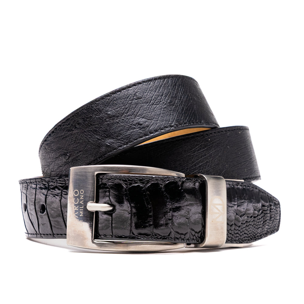 Alessio Belt Black by Marco Di Milano—a handcrafted leather belt in black with a textured finish and a silver buckle engraved with “ATELIER MILANO.” The belt is artfully coiled in a loose loop against a white background.