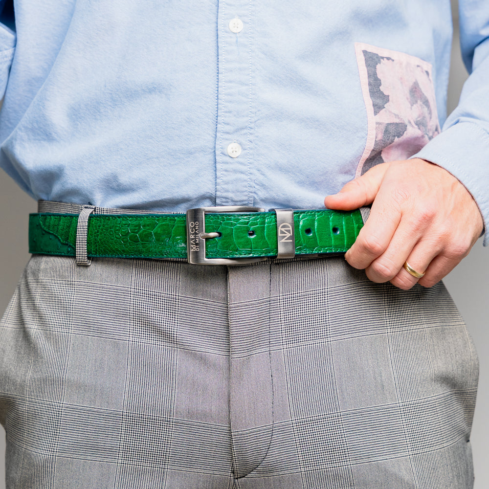 Introducing the Alessio Belt Lemon Green by Marco Di Milano—a coiled green leather belt with a silver buckle, featuring an embossed texture and the brand name “Marco Di Milano” engraved on the buckle. This handcrafted luxury accessory is designed to elevate any wardrobe with its refined elegance.