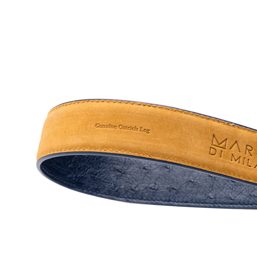 The Alessio Belt Navy by Marco Di Milano is a coiled blue handcrafted luxury belt with a silver buckle, featuring both smooth and textured crocodile-patterned sections.