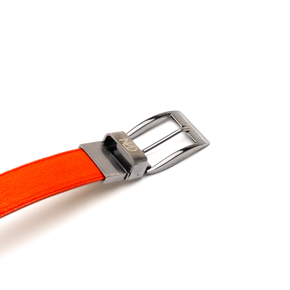 Introducing the Alessio Belt Orange by Marco Di Milano—a striking luxury accessory crafted from genuine ostrich leather. This handcrafted belt features a vibrant orange hue, a distinctive textured pattern, and a silver buckle elegantly engraved with the “Marco Di Milano” branding. Rolled neatly with the buckle facing forward, it highlights its exceptional design and artisanal craftsmanship.