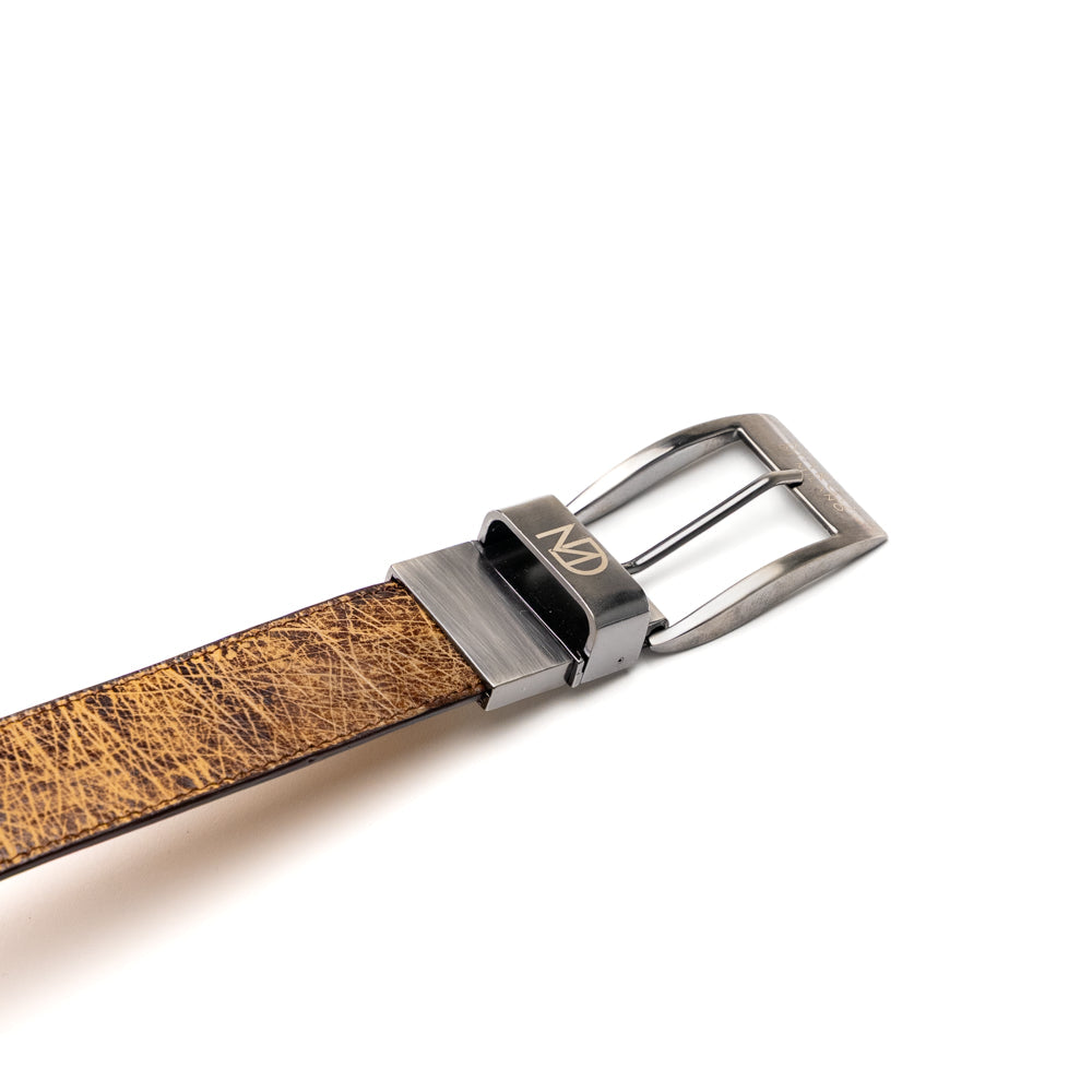 The Alessio Belt Orix by Marco Di Milano, featuring textured genuine ostrich leather in brown and a silver buckle, is coiled to display both its inside and outside surfaces.