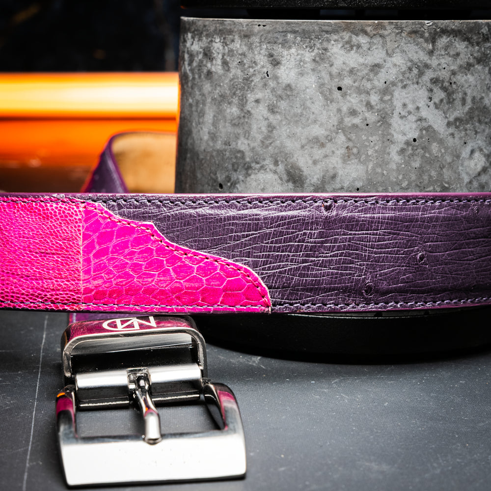 Introducing the Marco Di Milano Alessio Belt in Pink/Purple—a luxurious handcrafted accessory featuring a purple top side and a finely textured bright pink inner side, completed with a meticulously finished silver buckle engraved with the Marco Di Milano logo.