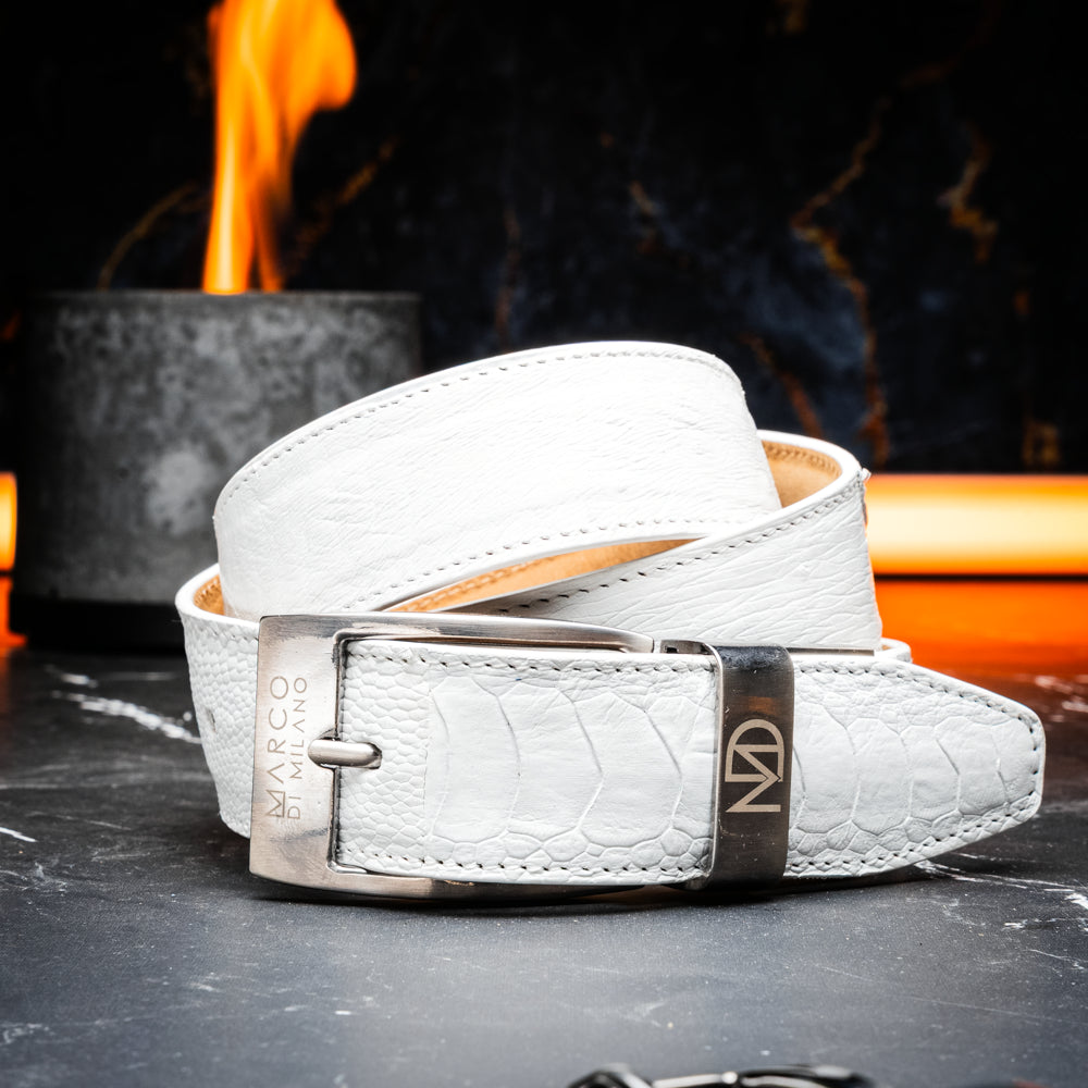 Introducing the Alessio Belt White by Marco Di Milano—a handcrafted luxury belt in pristine white leather, adorned with a silver buckle engraved with the brand’s iconic signature, elegantly coiled on a white background.