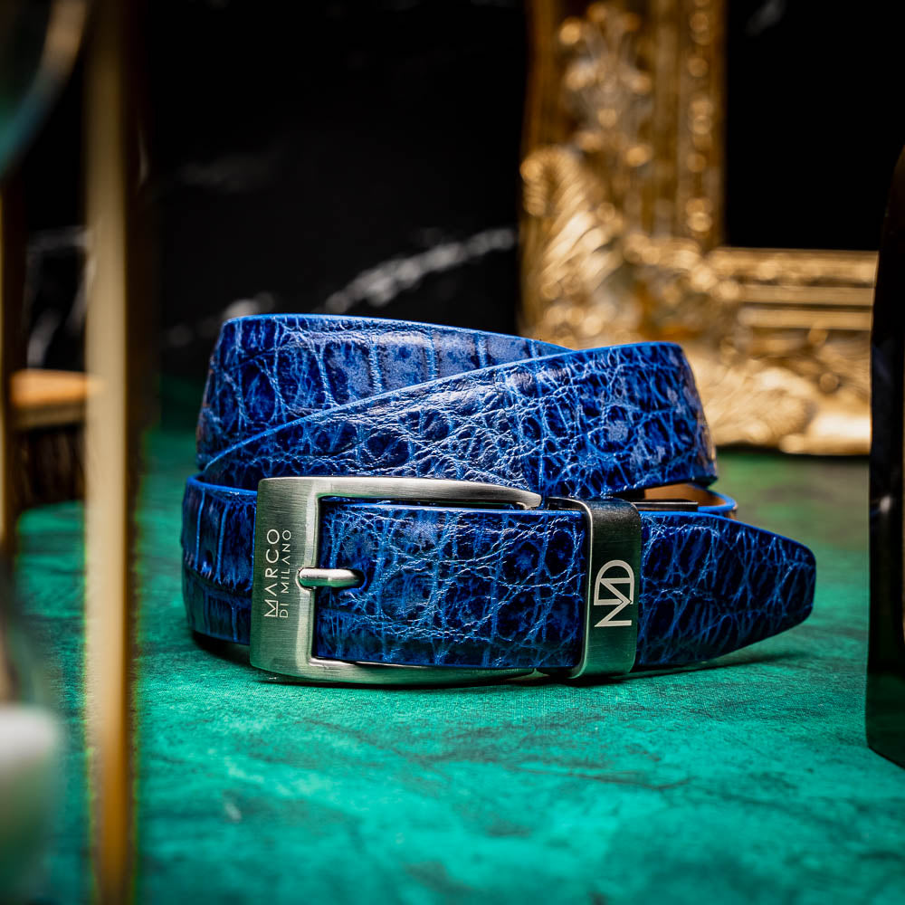 The Emilio Belt Antique Navy by Marco Di Milano features a rolled blue crocodile-patterned leather design and a silver rectangular buckle—ideal for pairing with Marco Di Milano's luxury footwear.