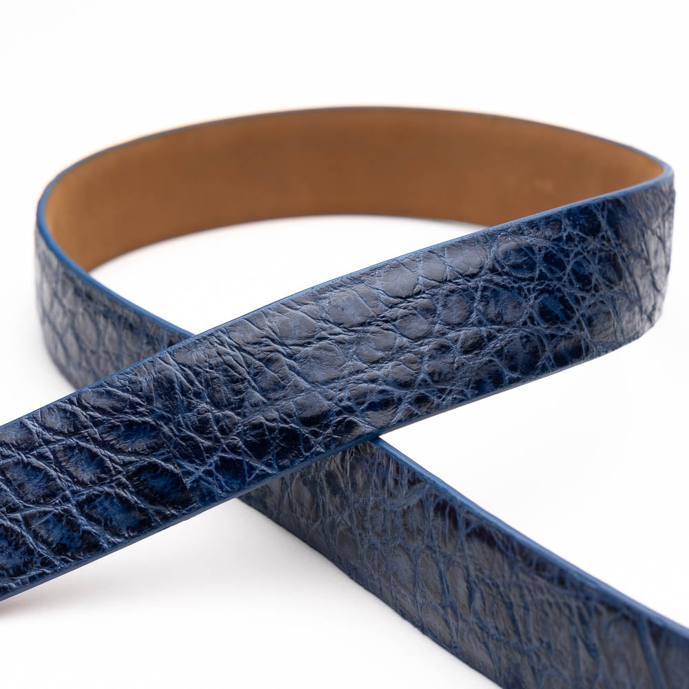 The Emilio Belt Antique Navy by Marco Di Milano features a rolled blue crocodile-patterned leather design and a silver rectangular buckle—ideal for pairing with Marco Di Milano's luxury footwear.