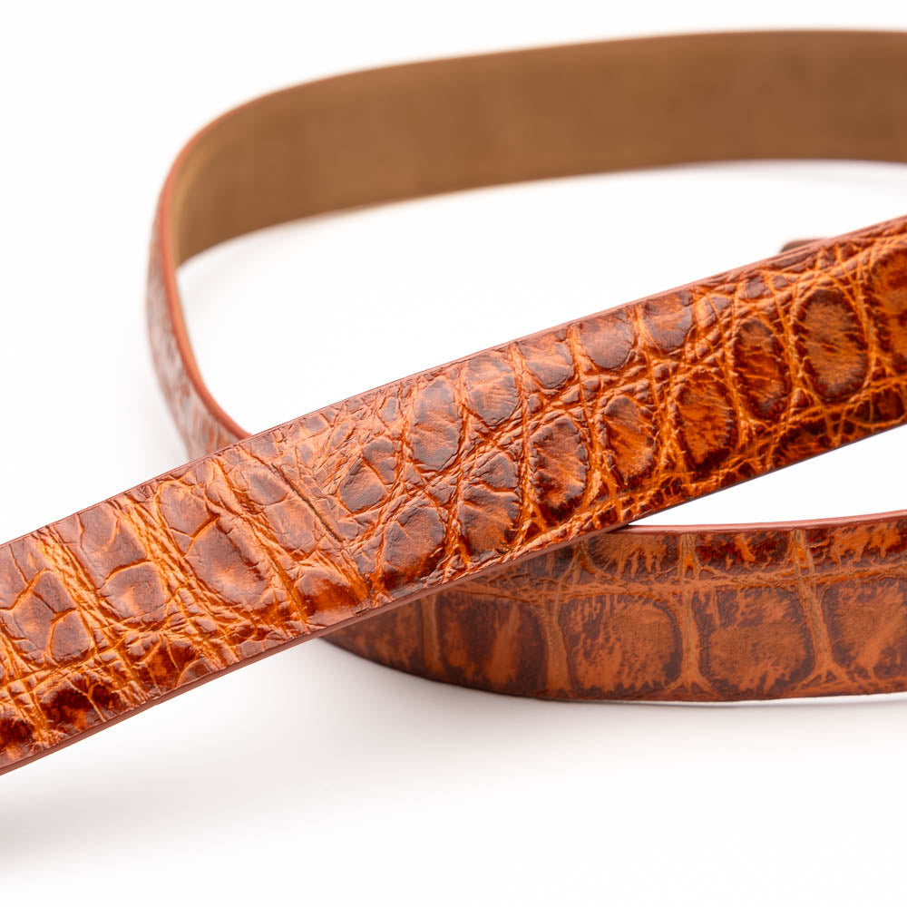The Emilio Belt Antique Honey by Marco Di Milano features a textured crocodile-pattern finish and a branded metal buckle—an elegant accessory that pairs perfectly with luxury footwear or genuine alligator belts.