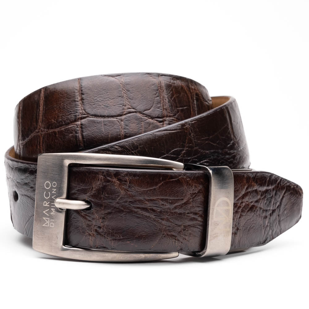 The Emilio Belt Brown by Marco Di Milano is a dark brown genuine alligator belt with a silver "Marco Donini" engraved buckle, coiled on a white background—designed to perfectly complement Marco Di Milano luxury footwear.