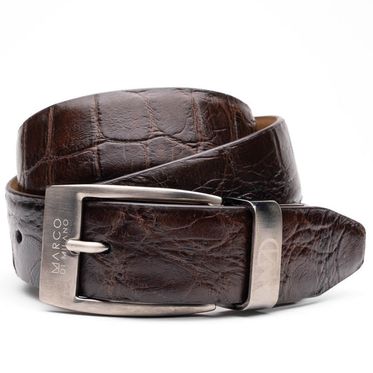 The Emilio Belt Brown by Marco Di Milano is a dark brown genuine alligator belt with a silver "Marco Donini" engraved buckle, coiled on a white background—designed to perfectly complement Marco Di Milano luxury footwear.