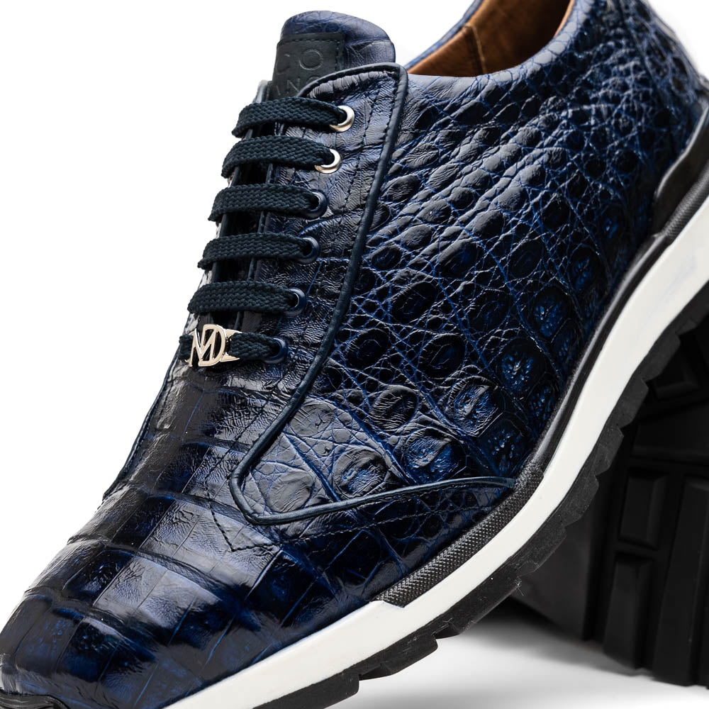 The Alonzo Navy by Marco Di Milano is a luxury men's sneaker in genuine caiman crocodile leather, featuring black laces, a hand-painted finish, white midsole, and black textured outsole.