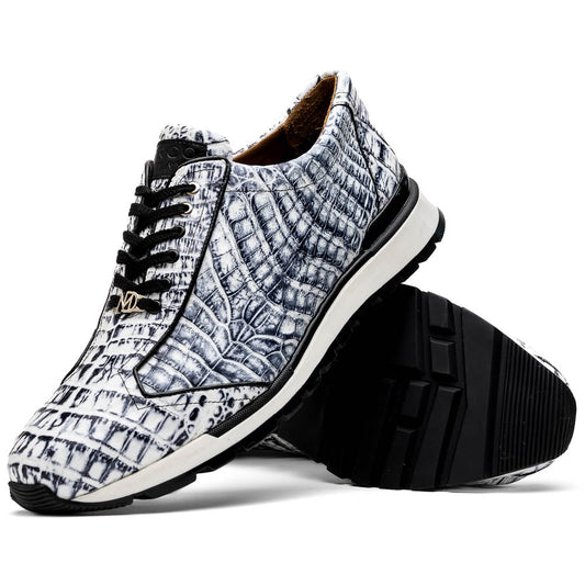 The Alonzo Newspaper sneakers by Marco Di Milano feature genuine caiman crocodile in white and black with a hand-painted finish, black laces, and black rubber soles, displayed with one shoe propped on the other against a white background.