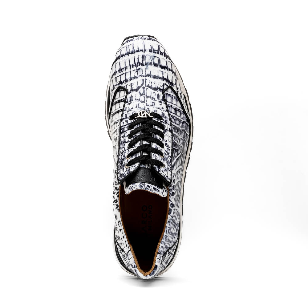 The Alonzo Newspaper sneakers by Marco Di Milano feature genuine caiman crocodile in white and black with a hand-painted finish, black laces, and black rubber soles, displayed with one shoe propped on the other against a white background.