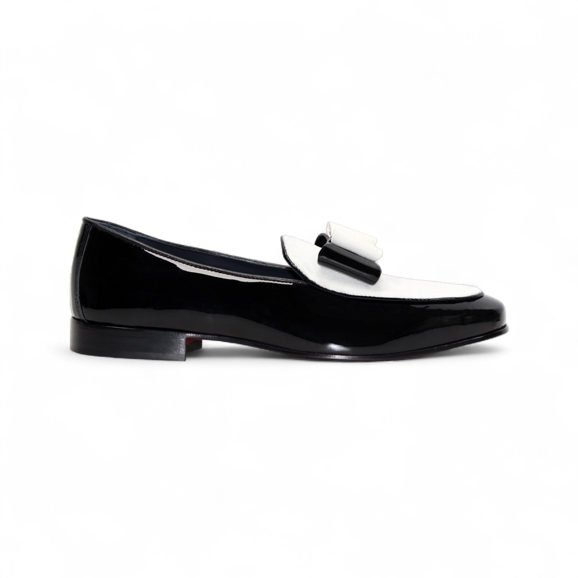 The Duca Di Matiste Amalfi loafer in black and white features a patent leather design, low heel, decorative bow, and Italian craftsmanship. Available in store size 9.5 only (final sale), shown on a plain white background.