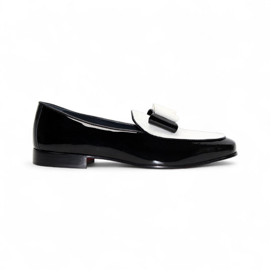 The Duca Di Matiste Amalfi loafer in black and white features a patent leather design, low heel, decorative bow, and Italian craftsmanship. Available in store size 9.5 only (final sale), shown on a plain white background.