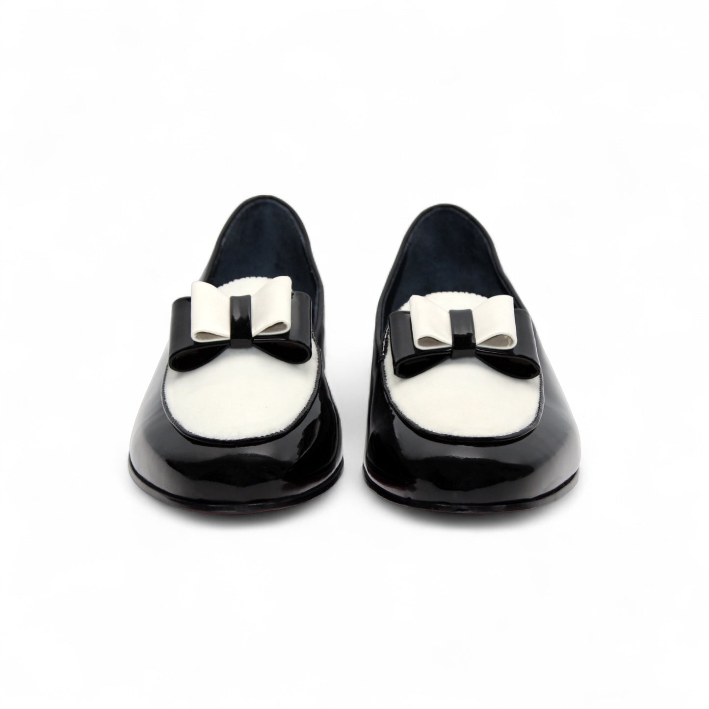 The Duca Di Matiste Amalfi loafer in black and white features a patent leather design, low heel, decorative bow, and Italian craftsmanship. Available in store size 9.5 only (final sale), shown on a plain white background.
