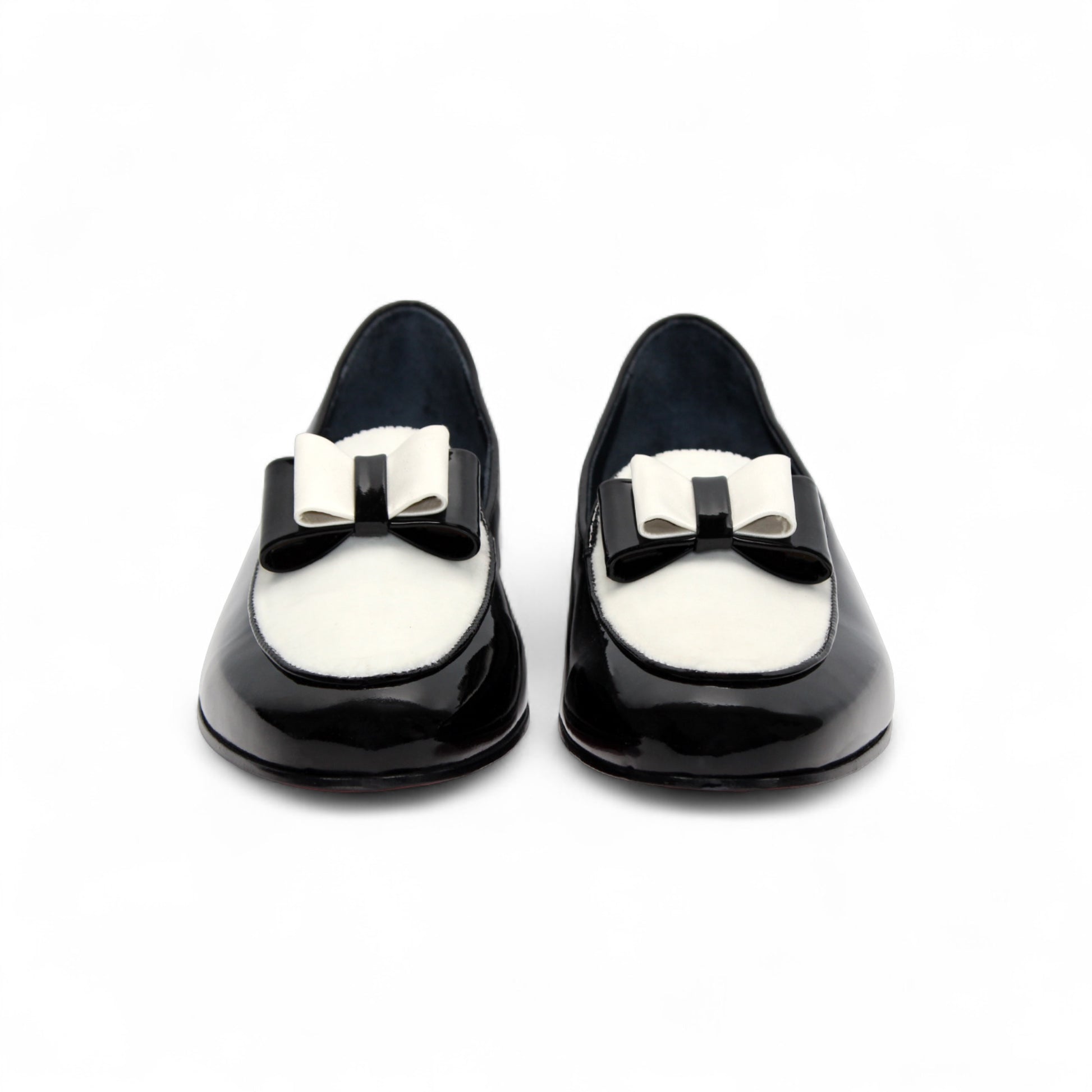 The Duca Di Matiste Amalfi loafer in black and white features a patent leather design, low heel, decorative bow, and Italian craftsmanship. Available in store size 9.5 only (final sale), shown on a plain white background.