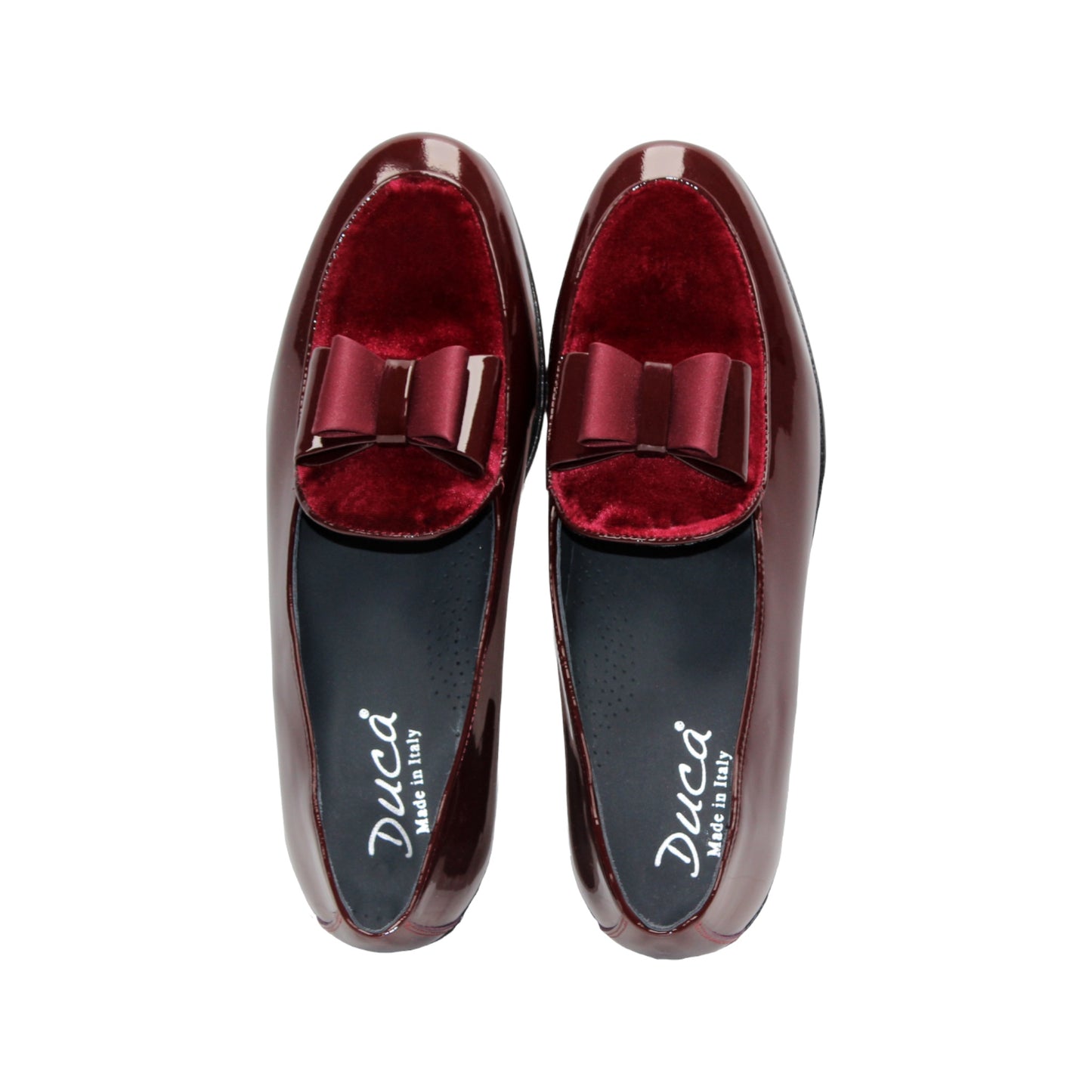 The Duca Amalfi Burgundy by Duca Di Matiste, a burgundy patent leather loafer with a low heel and matching bow, is shown side view on white, capturing refined Italian luxury and expert craftsmanship.