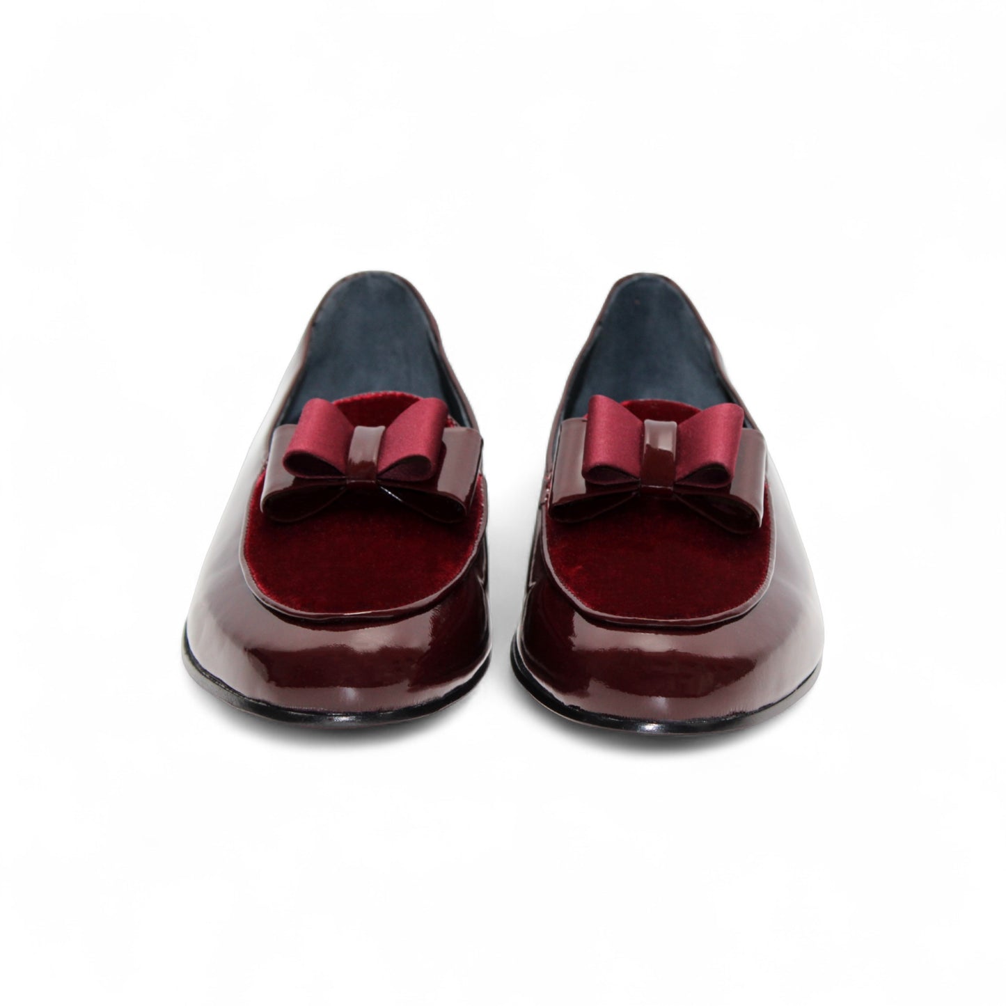 The Duca Amalfi Burgundy by Duca Di Matiste, a burgundy patent leather loafer with a low heel and matching bow, is shown side view on white, capturing refined Italian luxury and expert craftsmanship.