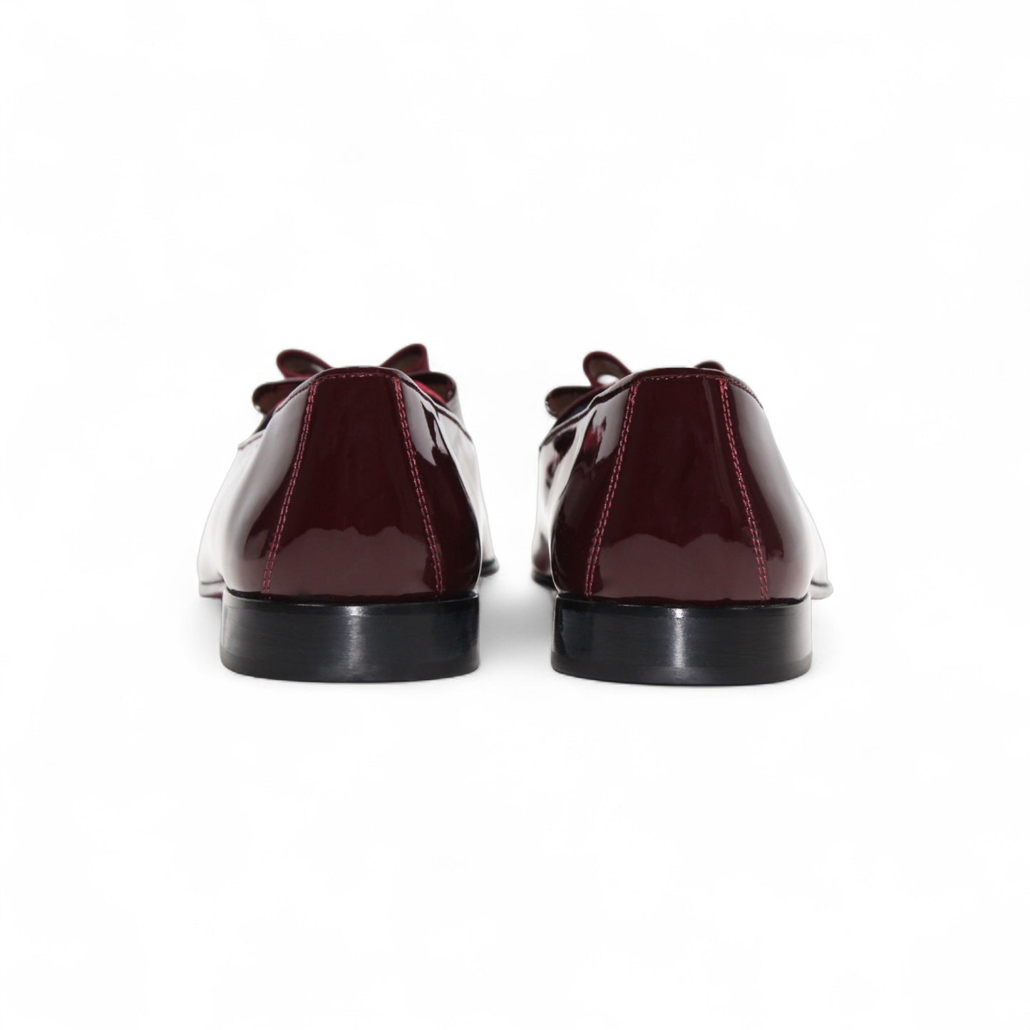 The Duca Amalfi Burgundy by Duca Di Matiste, a burgundy patent leather loafer with a low heel and matching bow, is shown side view on white, capturing refined Italian luxury and expert craftsmanship.